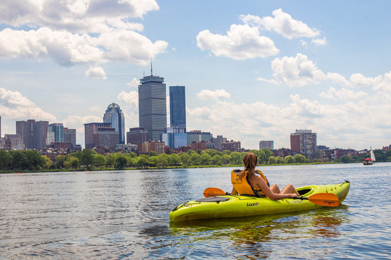 Girl in kayak with Boston Skyline in the back
