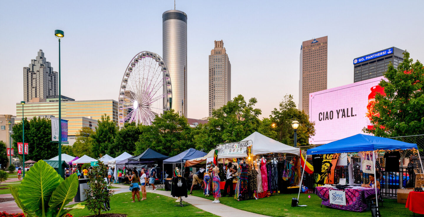Evening shot of One MusicFest vendor booths featurng the Downtown Atlanta, Georgia, skyline.
