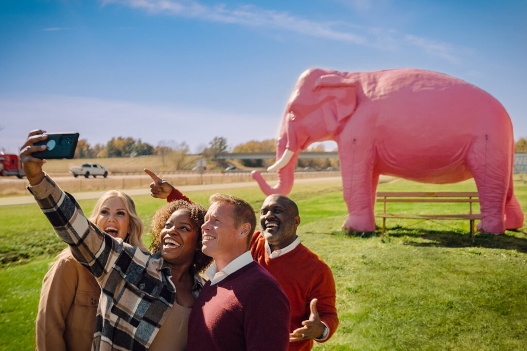 Posing with the giant pink elephant statue outside Pink Elephant Antique Mall in Livingston, Illinois