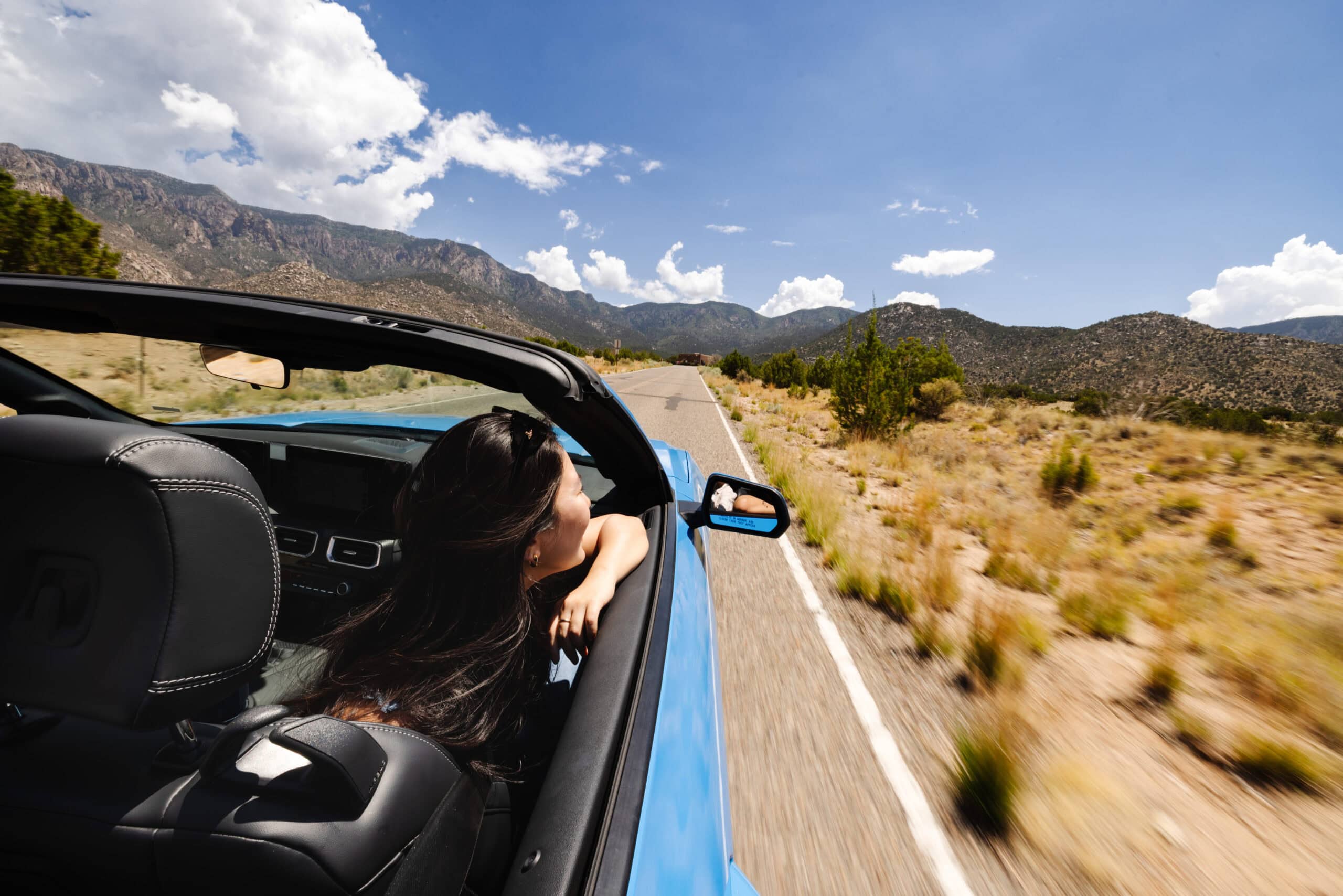 Woman rides in convertible in Albuquerque, NM