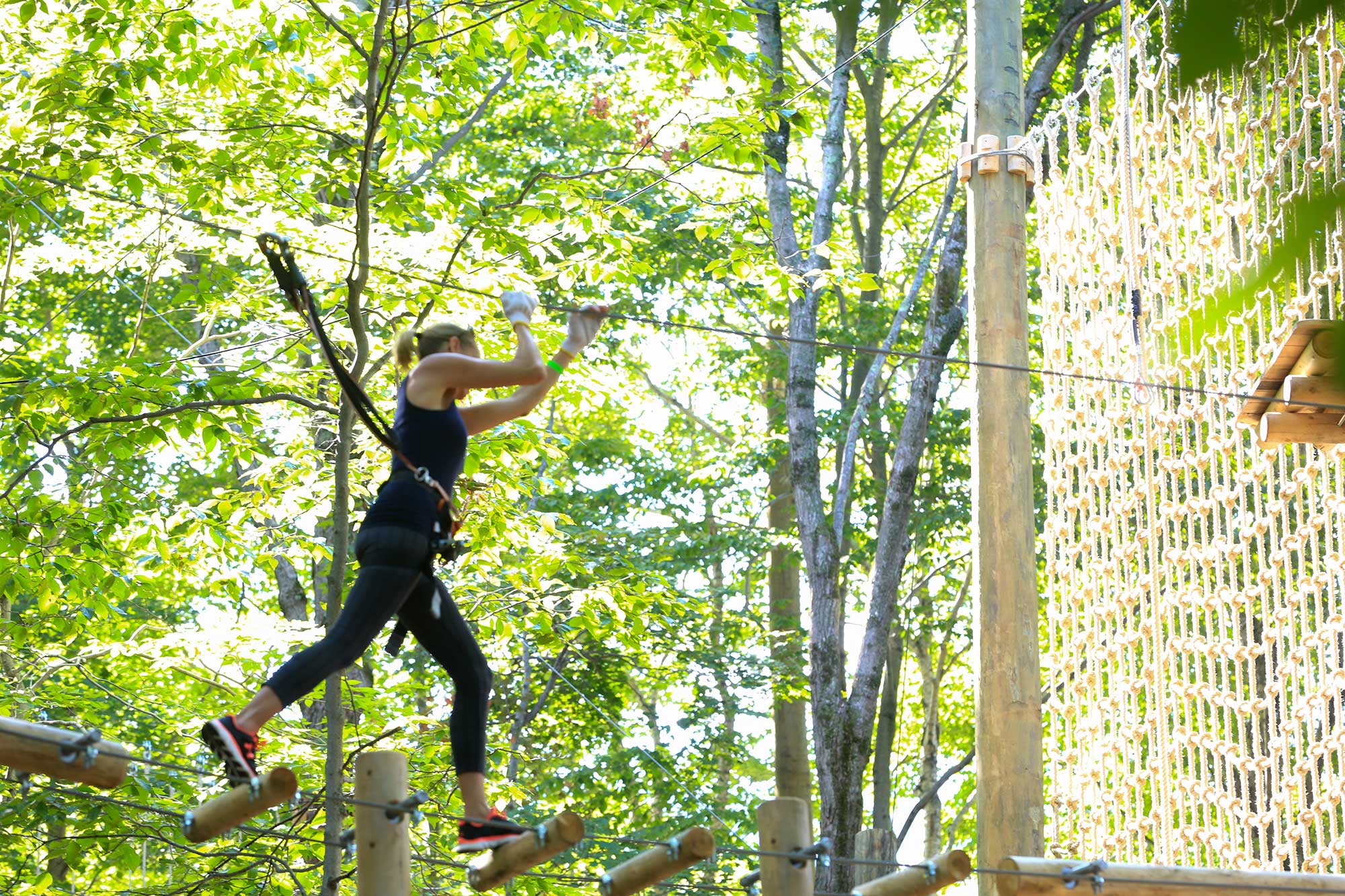Navigating a treetop challenge course near Stowe, Vermont