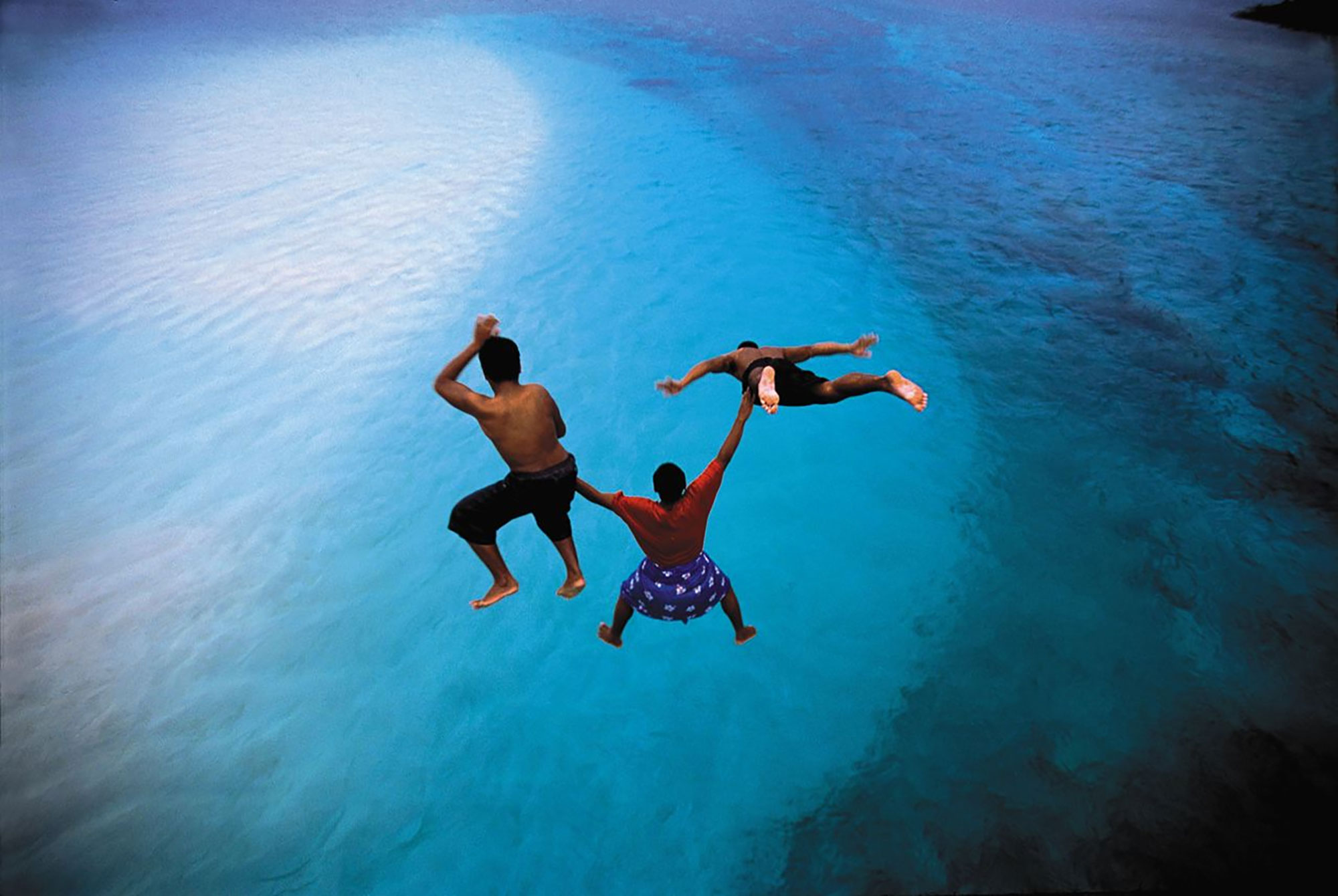 Travelers jumping into a harbor of Aunu’u in American Samoa 
