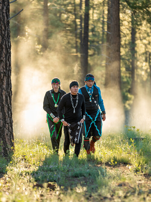 Indigenous men walking in the Coconino National Forest in Flagstaff, Arizona