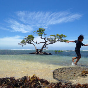 A boy splashes in the water on the coast of Ponce, Puerto Rico
