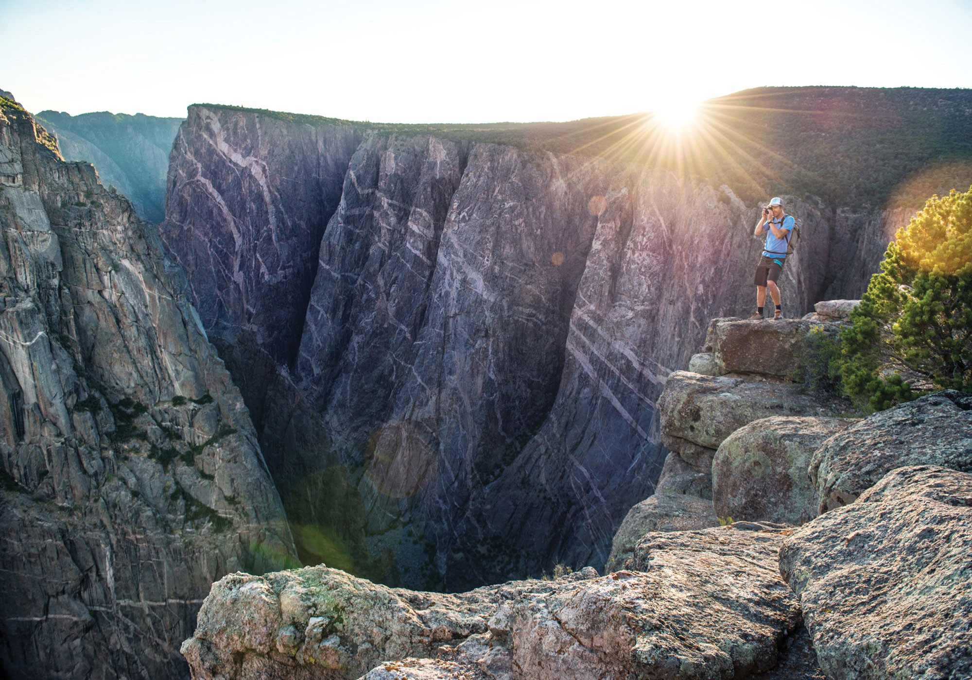 Hiker taking a photo at the Black Canyon of the Gunnison National Park in Colorado.