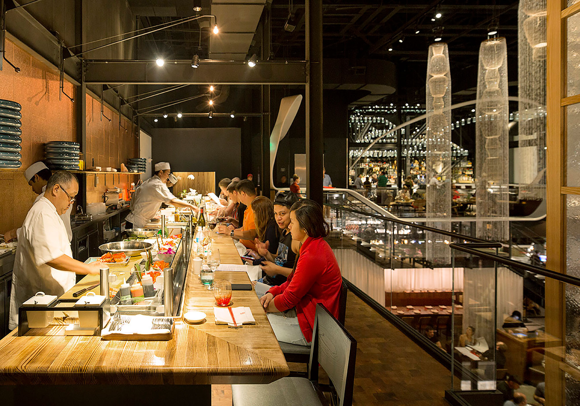Visitors at the sushi bar of Morimoto Asia at Disney Springs near Orlando, Florida
