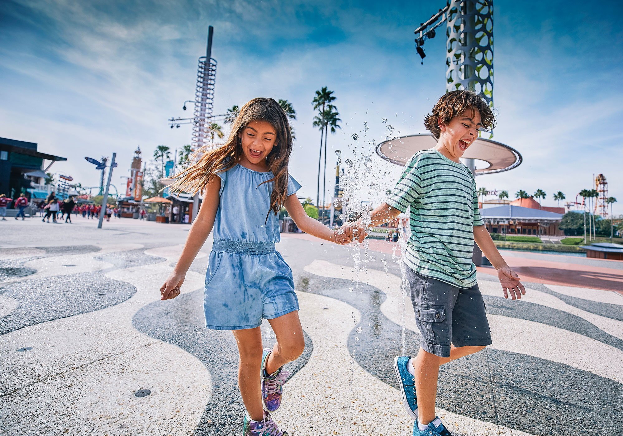 Two kids enjoying the splash pad at Universal CityWalk near Orlando, Florida.