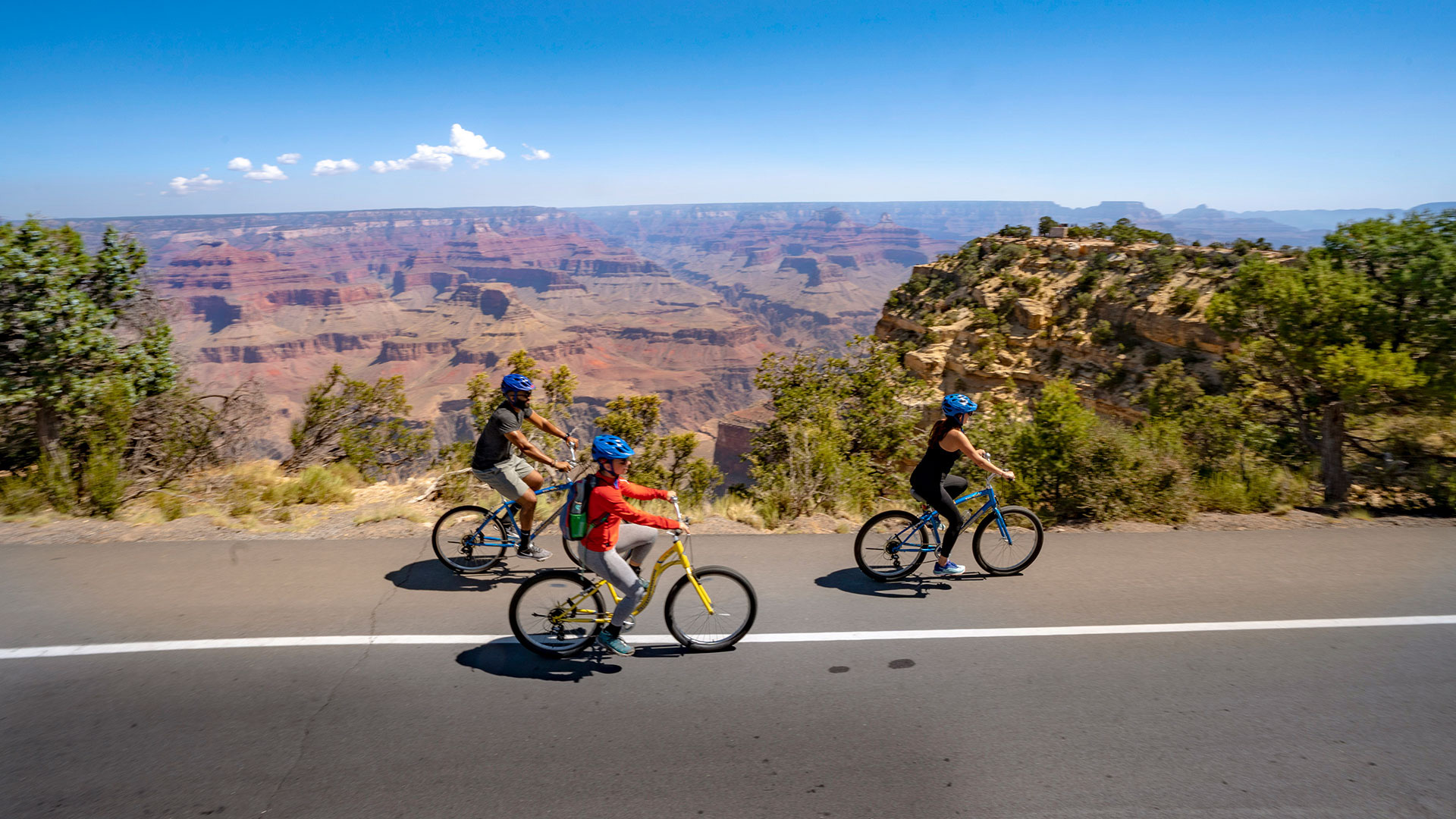 Cyclists riding alongside the Grand Canyon in Arizona