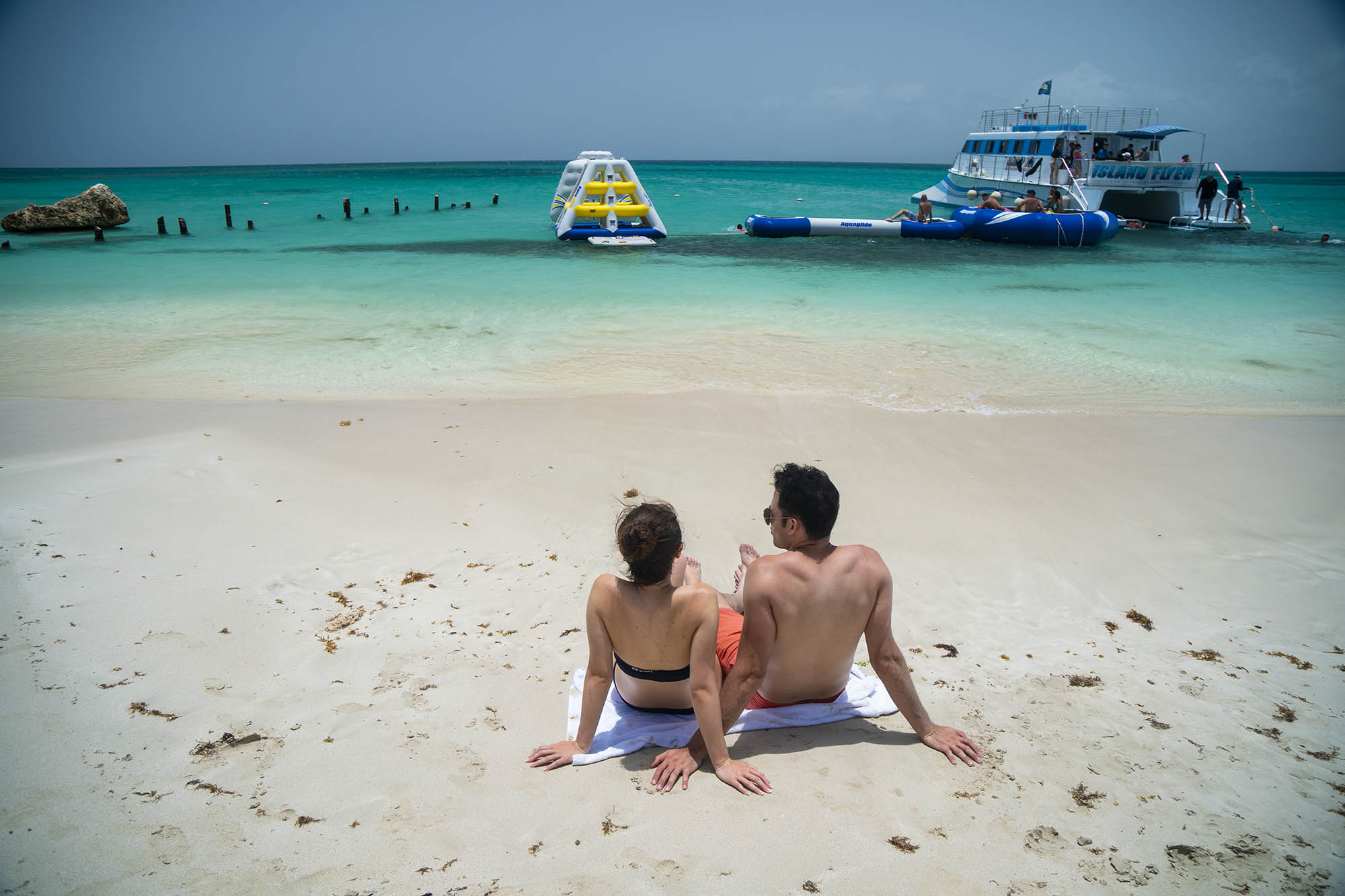 A couple relaxing on the sand of Isla Caja de Muertos near Ponce, Puerto Rico