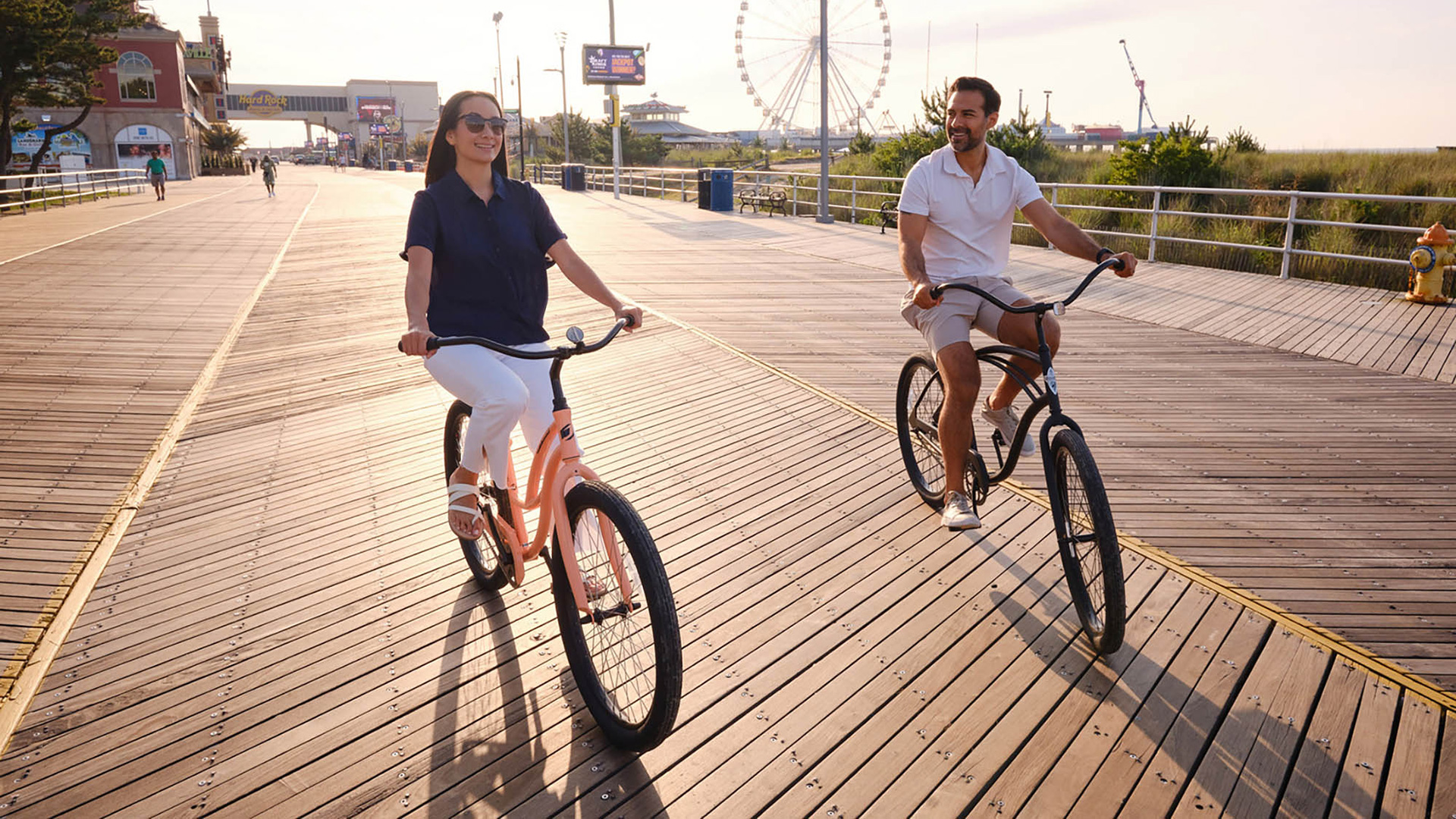 A couple biking the Atlantic City Boardwalk in Atlantic City, New Jersey