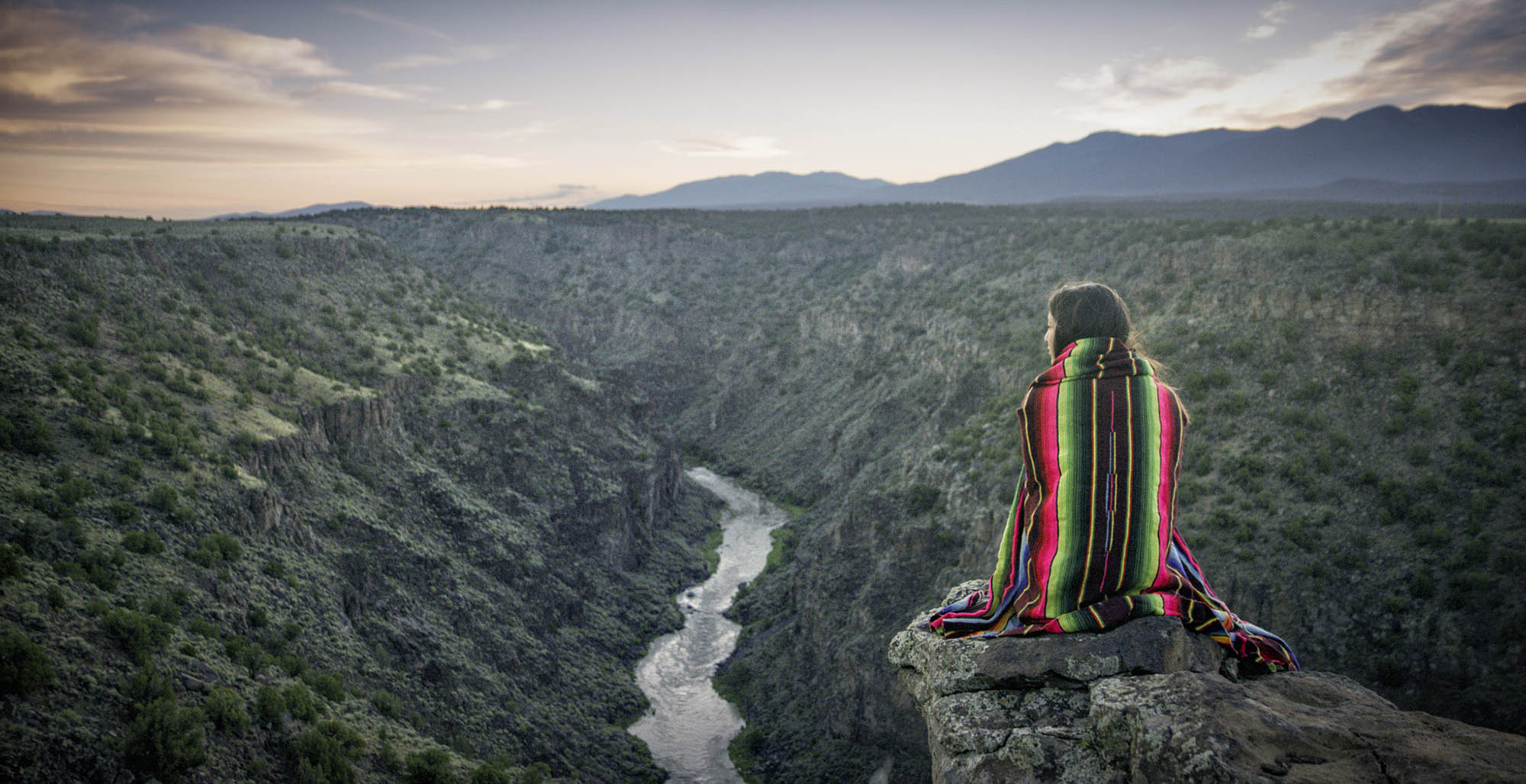 Gazing out at the Rio Grande Gorge, near Taos, New Mexico, from a high cliff; Credit: New Mexico True
