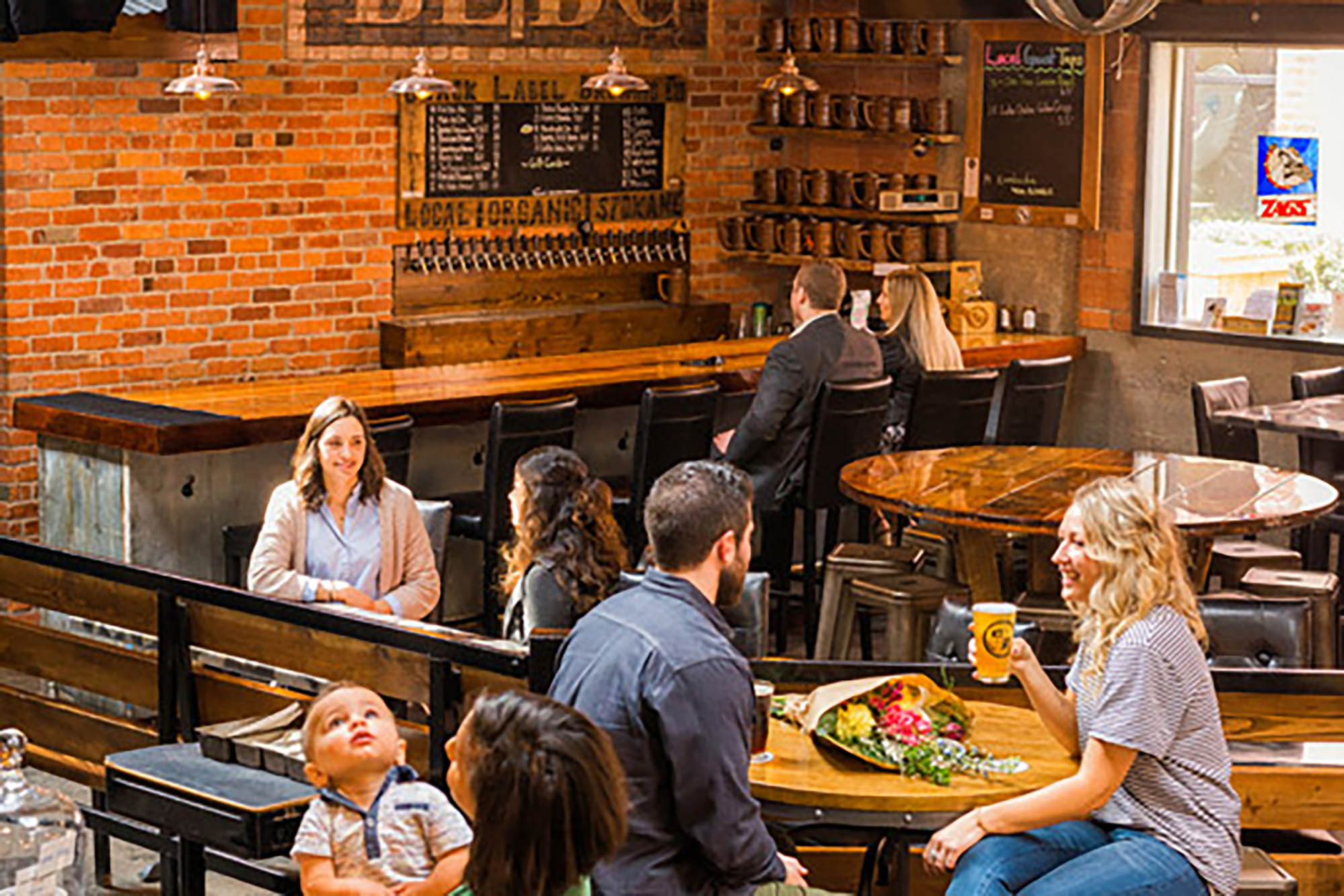 People drinking beer at the Black Label Brewing Company in Spokane, Washington; Credit: Visit Spokane