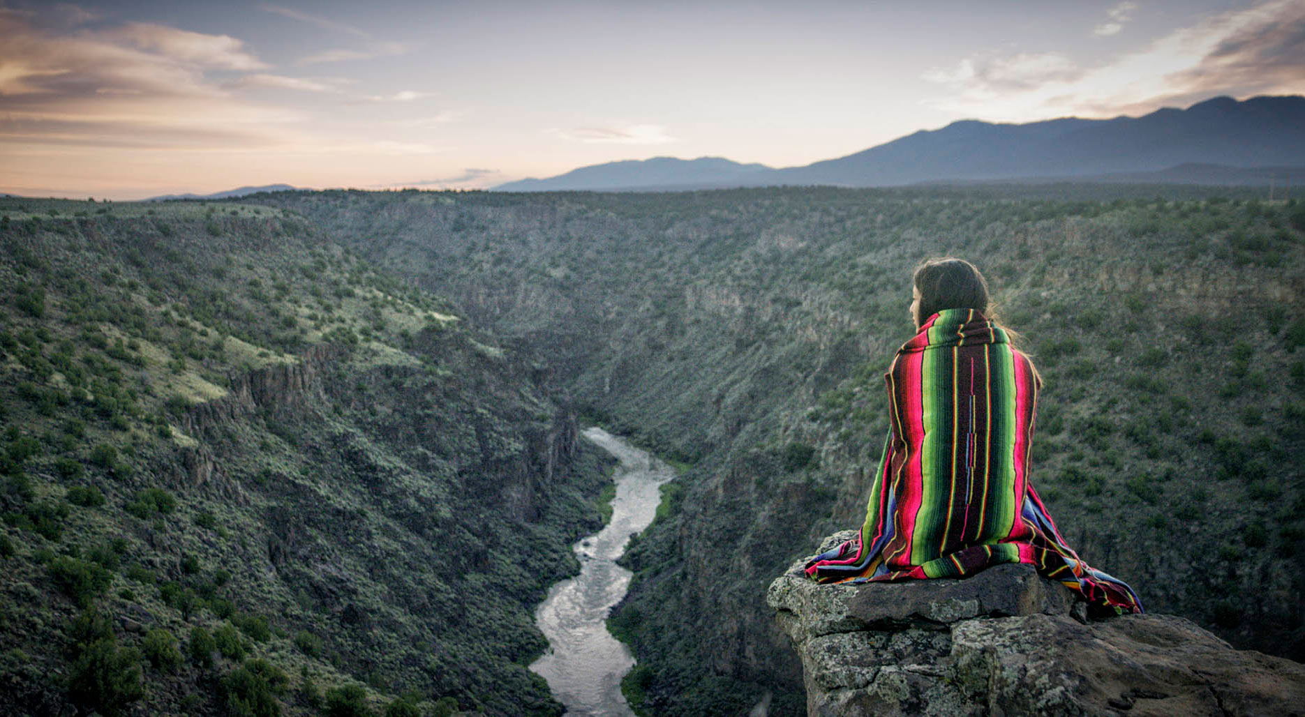 Gazing out at the Rio Grande Gorge, near Taos, New Mexico, from a high cliff; Credit: New Mexico True