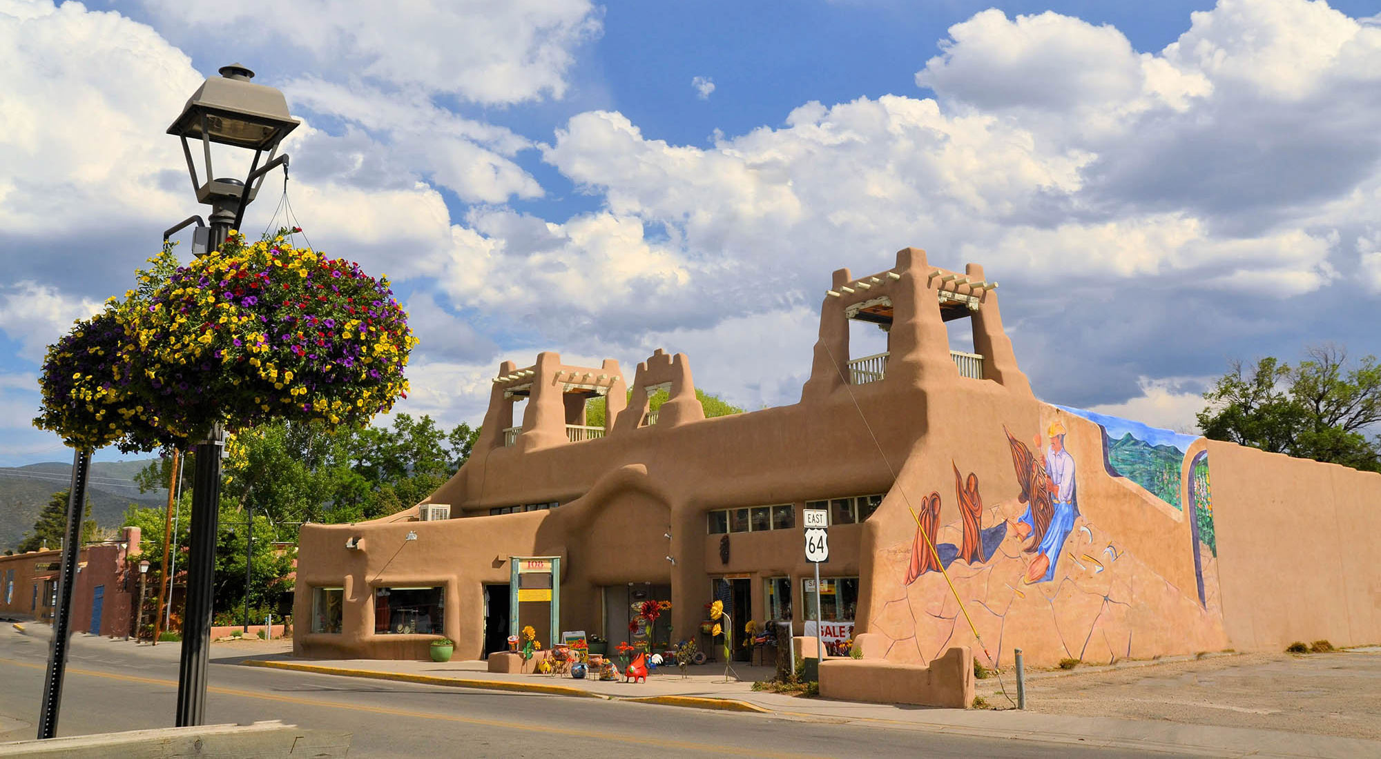 Street view including a mural on a downtown building in Taos, New Mexico