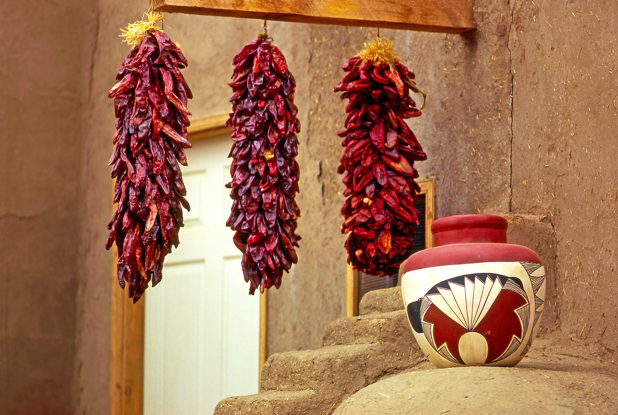 Pottery and peppers outside an adobe building in Taos, New Mexico