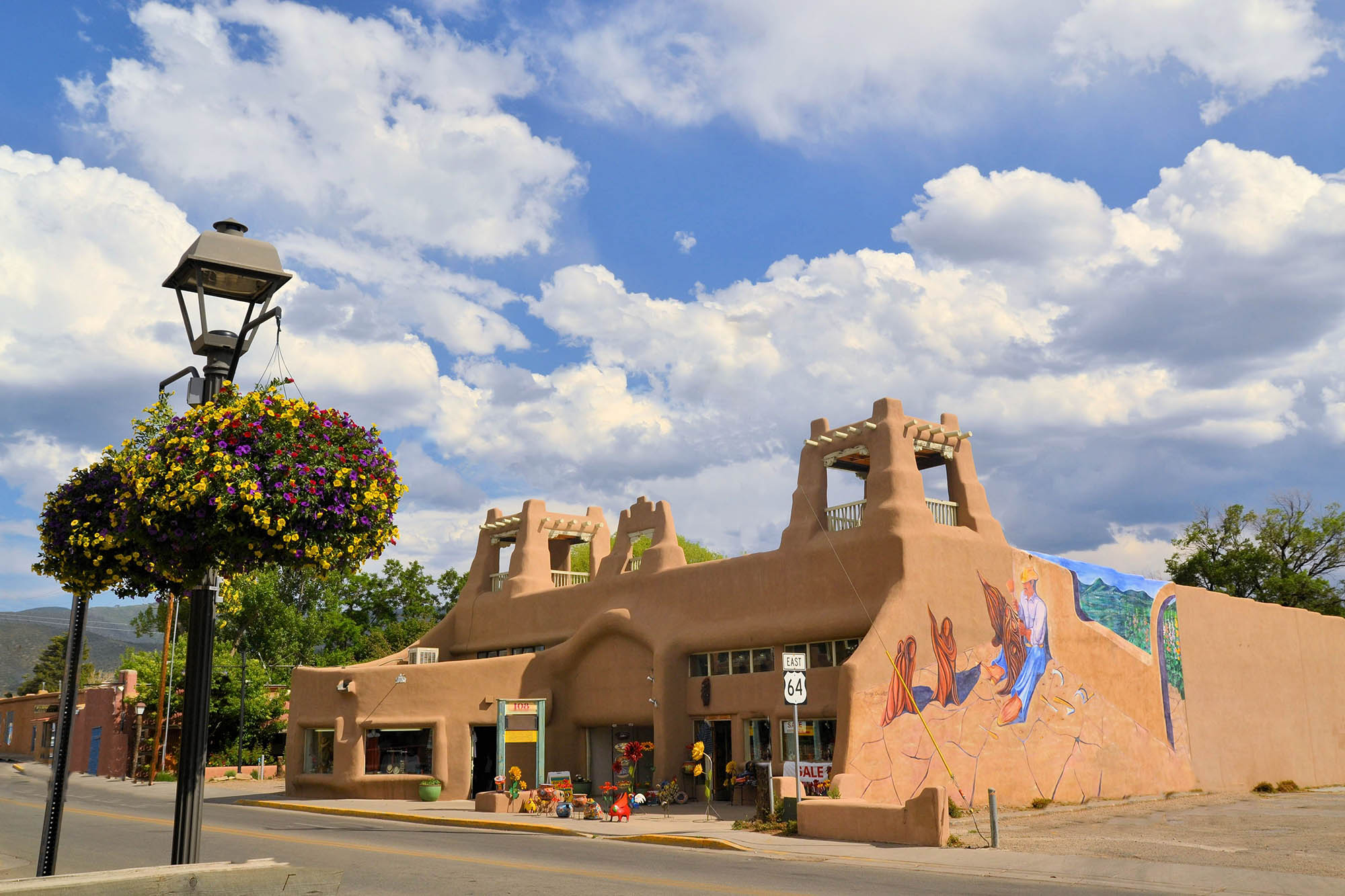 Street view including a mural on a downtown building in Taos, New Mexico
