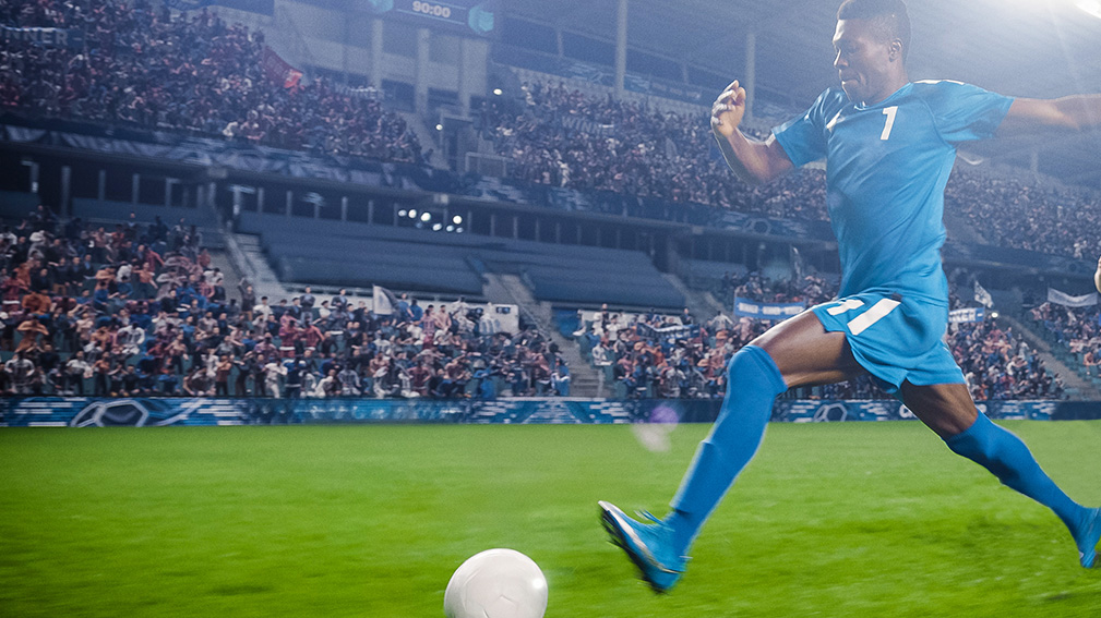 soccer player kicking ball