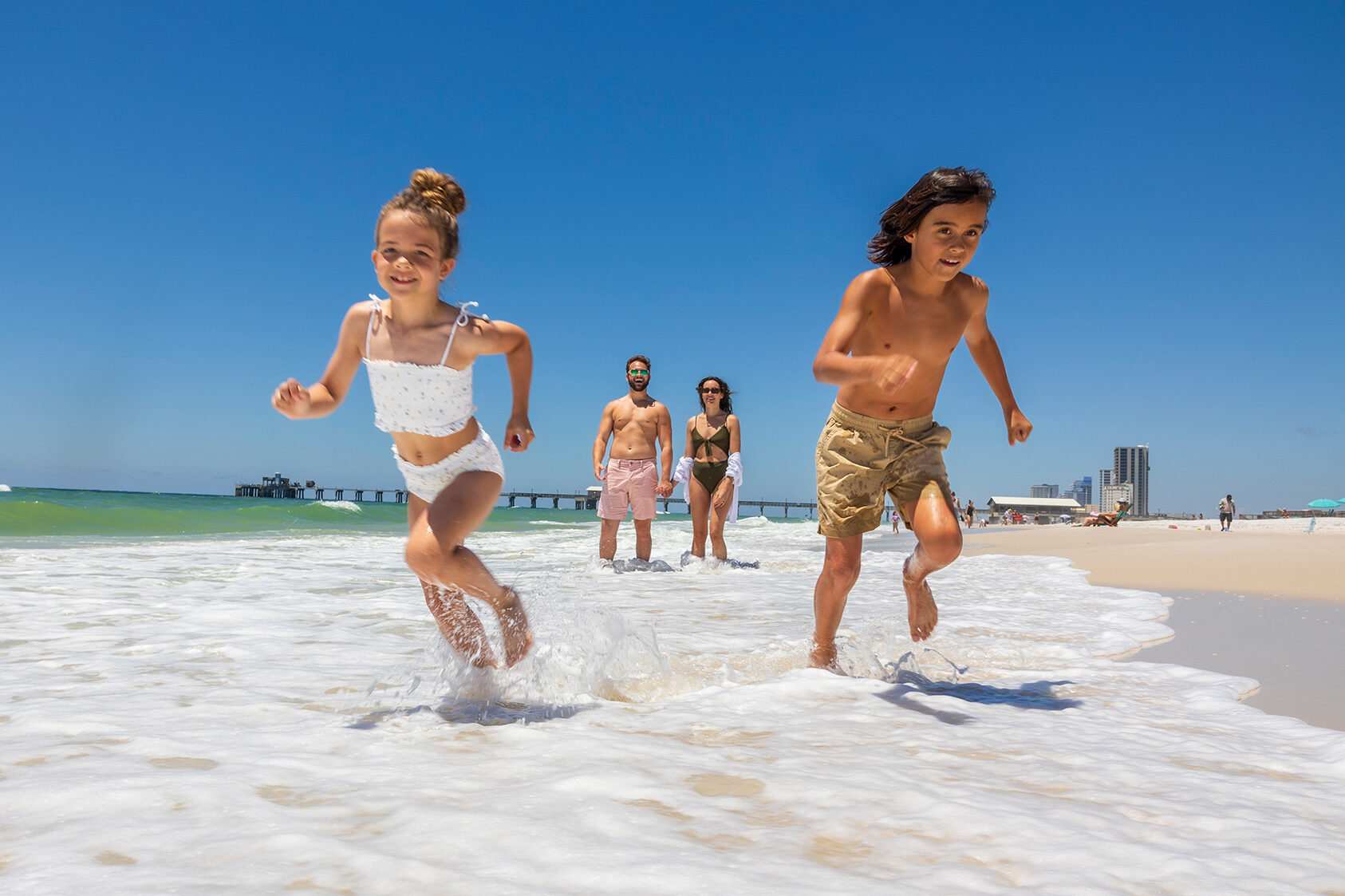 Family playing on the beach on Alabama's Gulf Coast