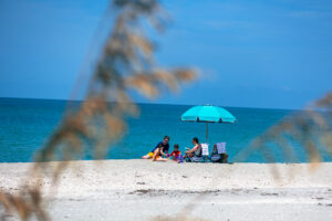 Family relaxing on the sand at Englewood Beach, Florida