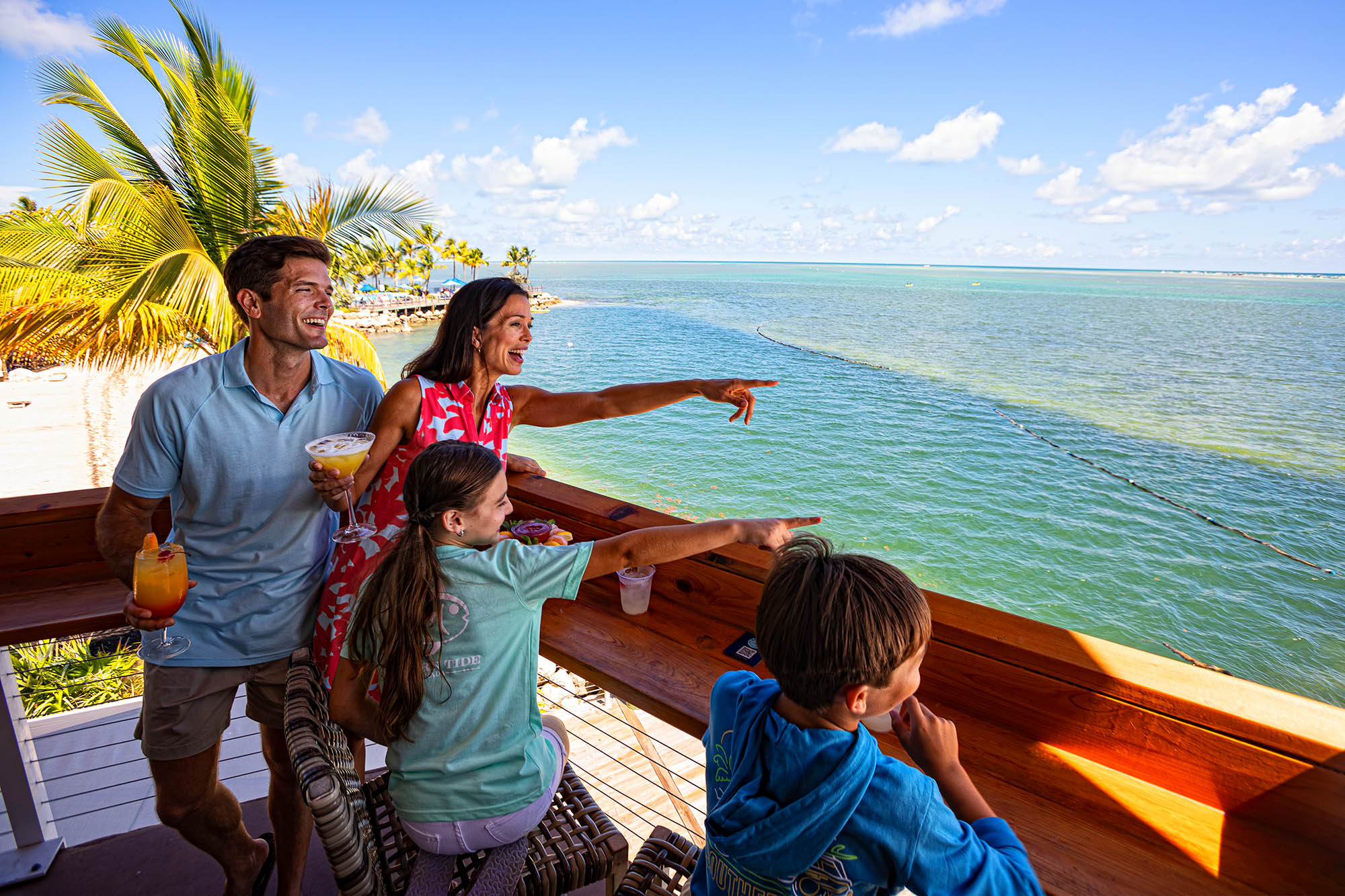 A family enjoying ocean views from their hotel balcony in The Florida Keys; Credit: Visit Florida Keys
