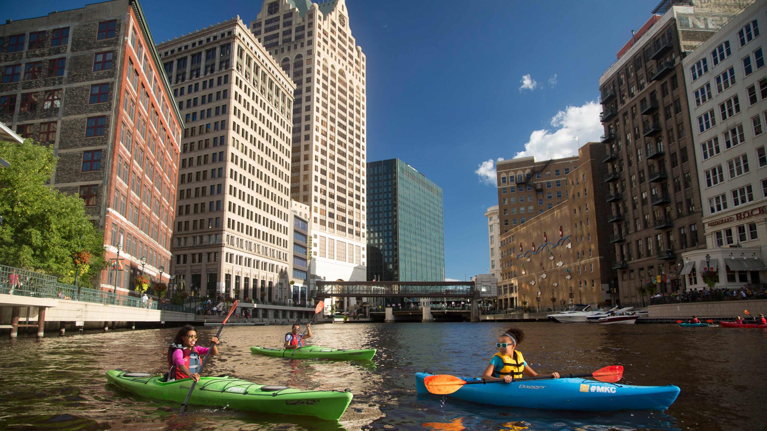 Kayakers on the Milwaukee River in downtown Milwaukee, Wisconsin; Credit: Visit Milwaukee