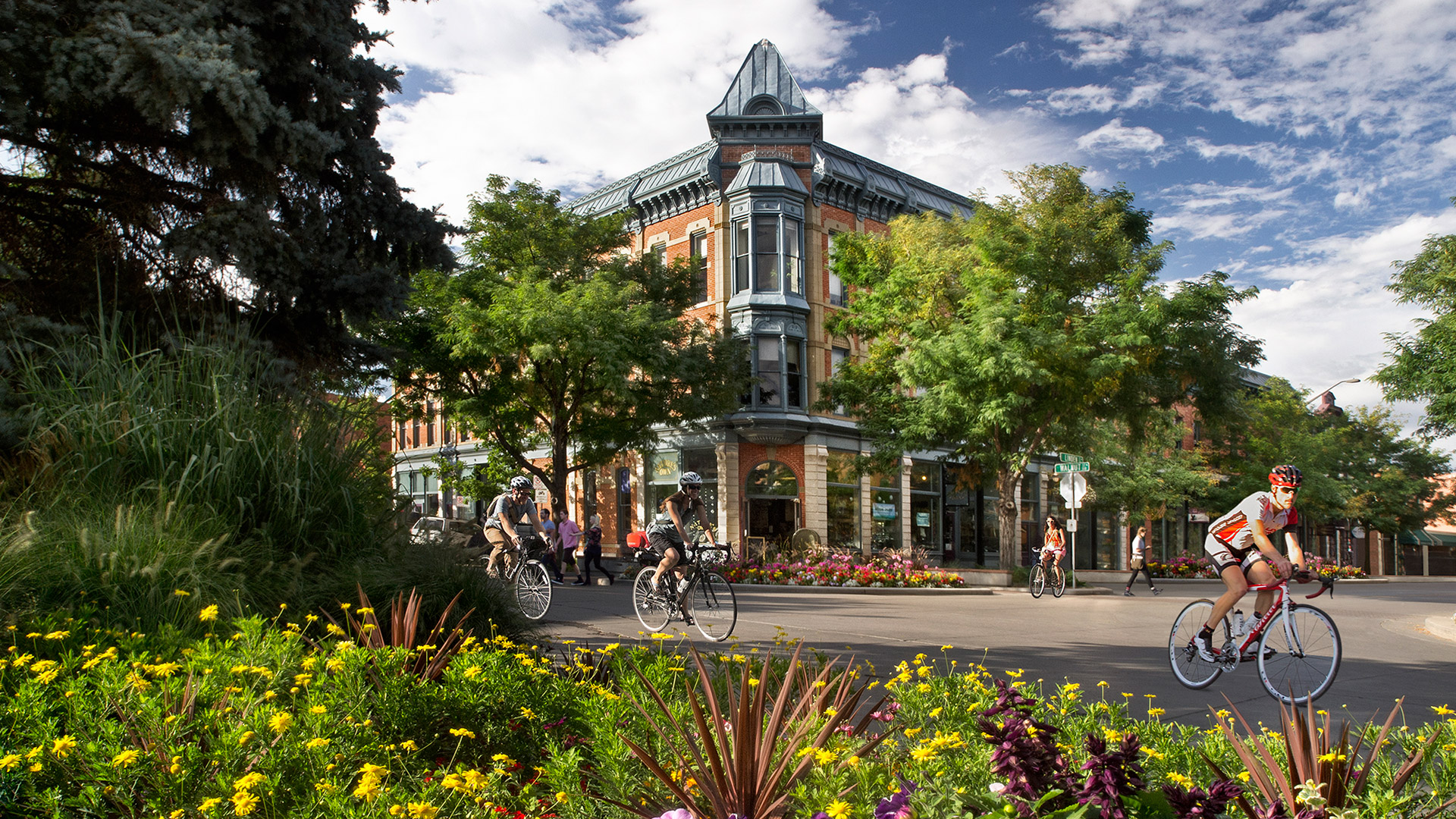 Cyclists passing the historic Linden Hotel in downtown Fort Collins, Colorado; Credit: Tim O’Hara