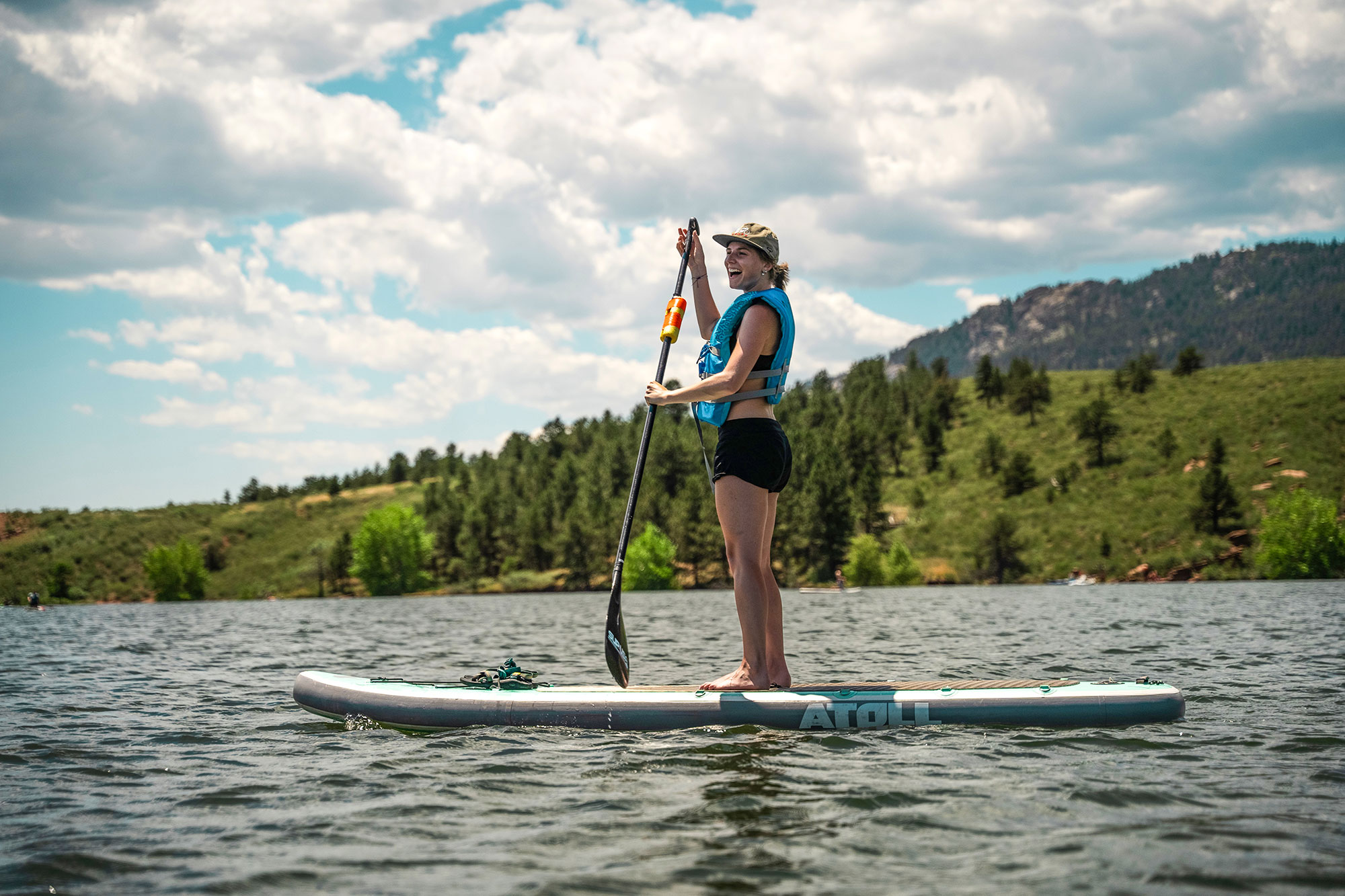 Standup paddleboarder in Satanka Cove of Horsetooth Reservoir in Fort Collins, Colorado; Credit: Visit Fort Collins