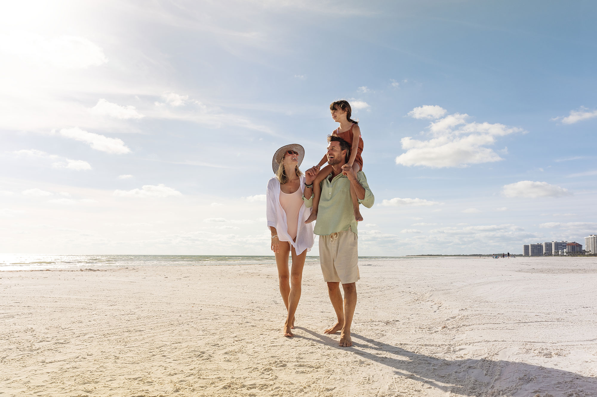 Family walking on the beach of Marco Island, Florida
