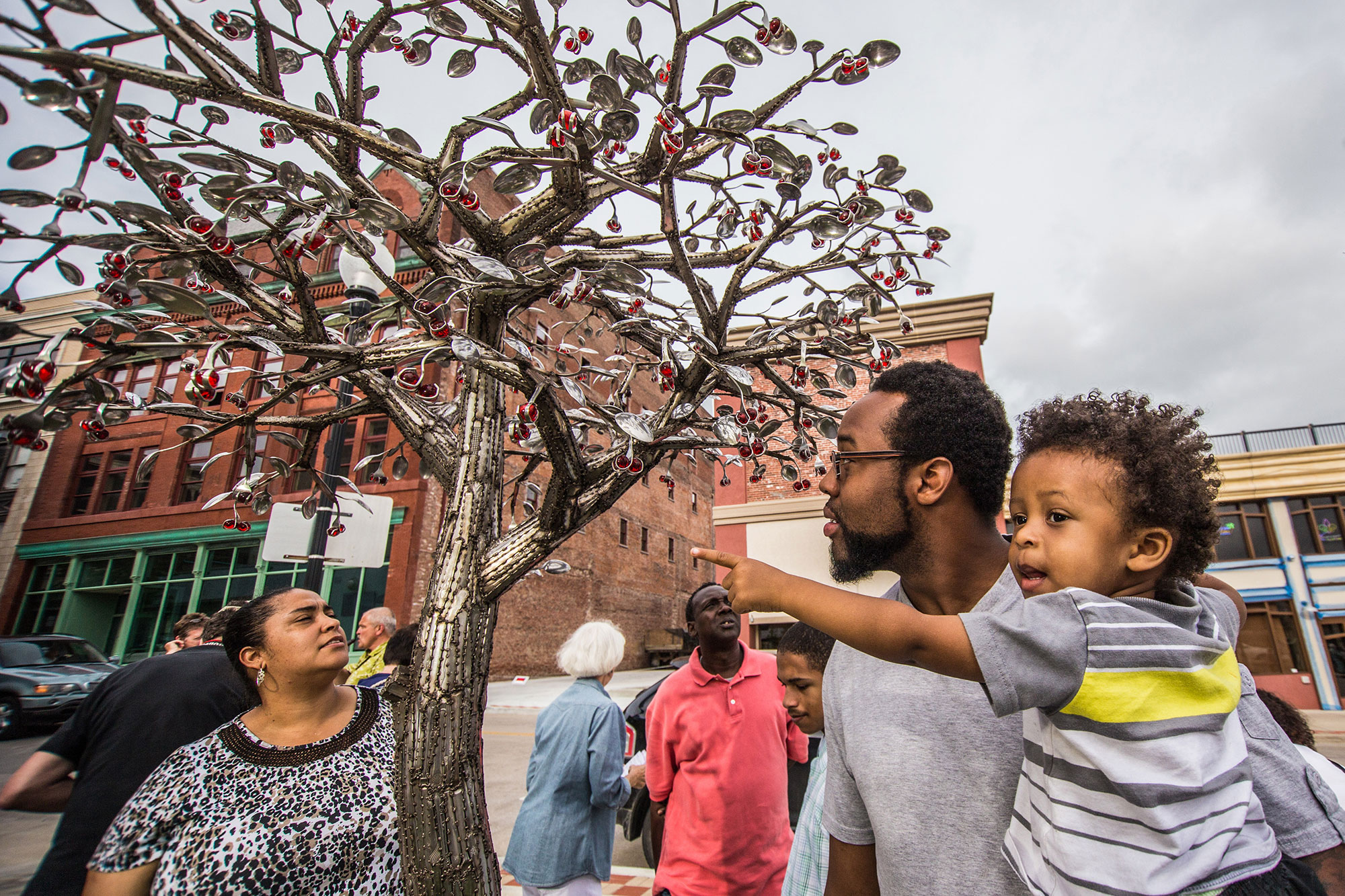 Family admiring works along the Sculpture Walk in St. Joseph, Missouri
