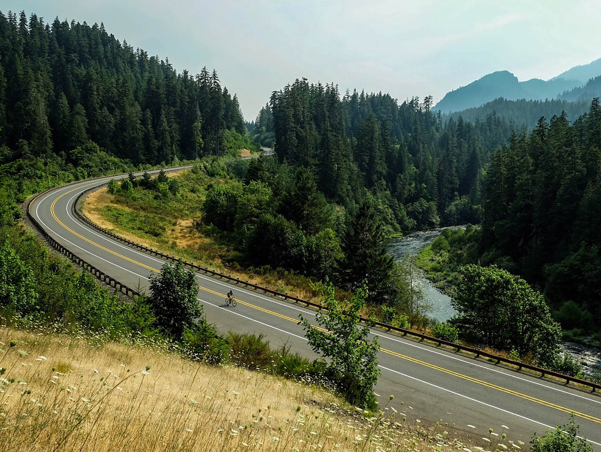 A cyclist rides along the Cascading Rivers Scenic Bikeway in Oregon’s Mt. Hood Territory; Credit: hood-gorge.com
