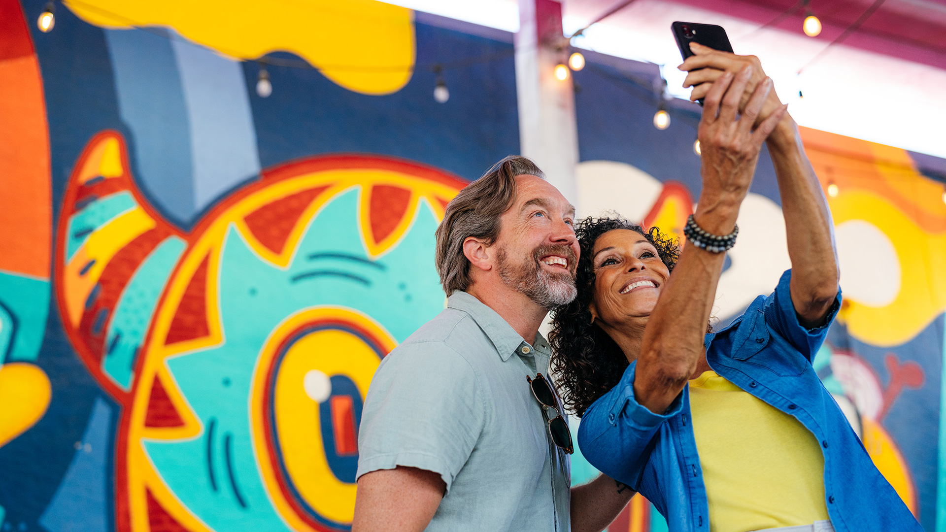 Couple posing with a mural in Panama City, Florida