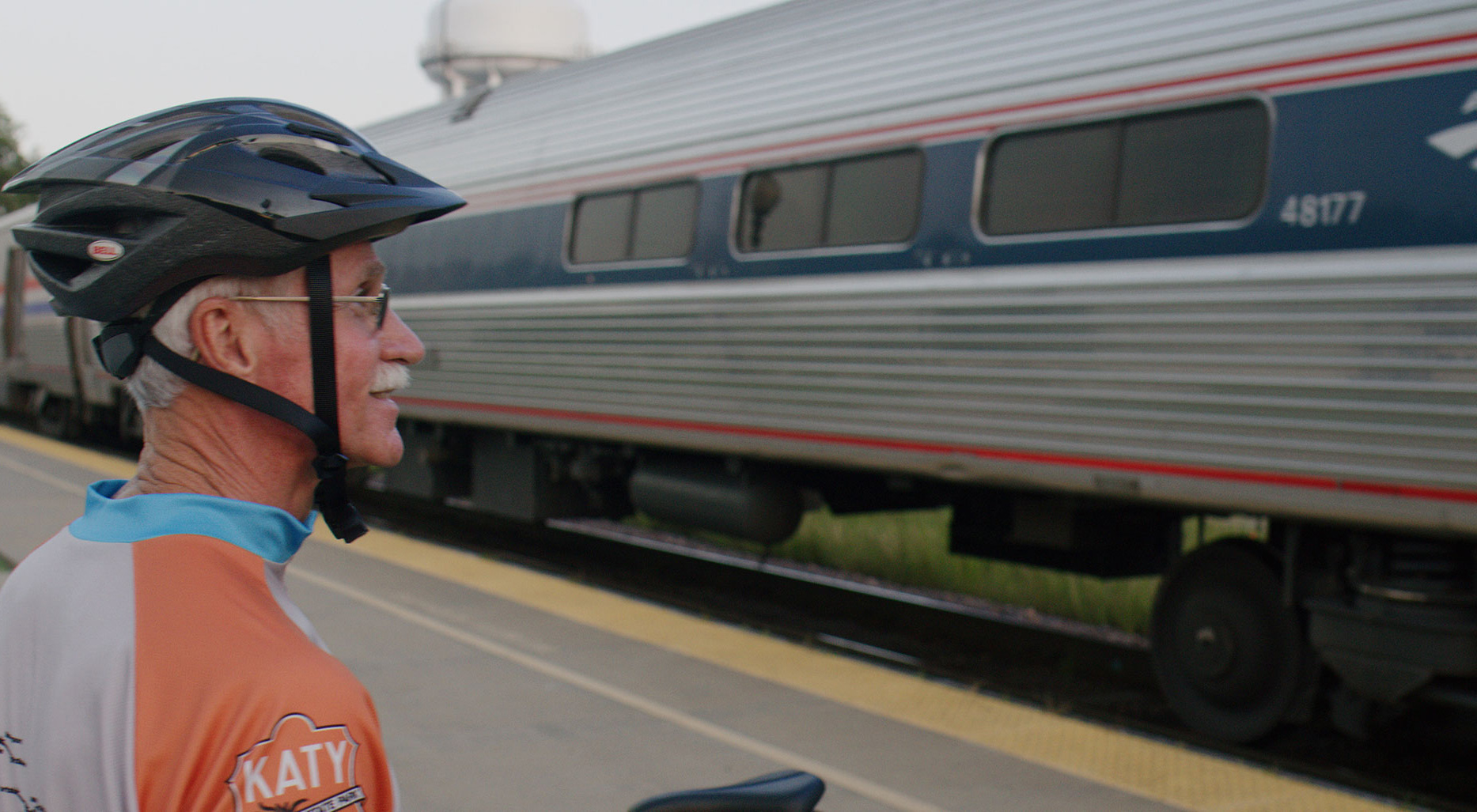 Cyclists watching the Amtrak Missouri River Runner train go through Sedalia, Missouri