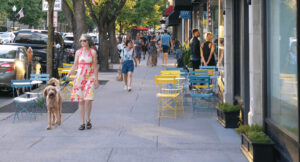 A woman walking her dog in downtown Morristown in Morris County, New Jersey