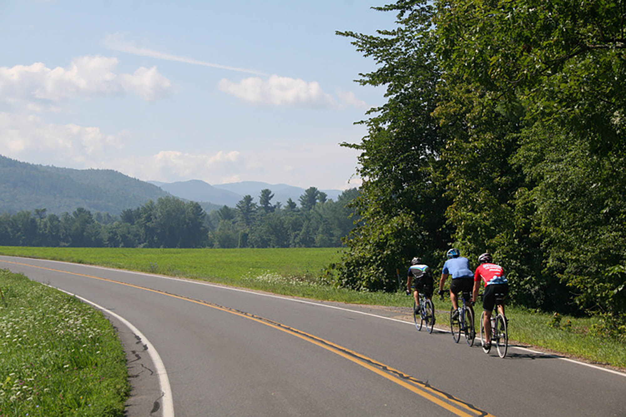 A group of three biking in the Adirondack Mountains in Plattsburgh, New York