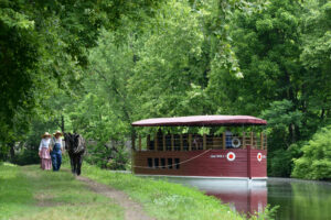 Costumed interpreters towing a boat along the Lehigh Canal in Lehigh Valley, Pennsylvania; Credit: Discover Lehigh Valley