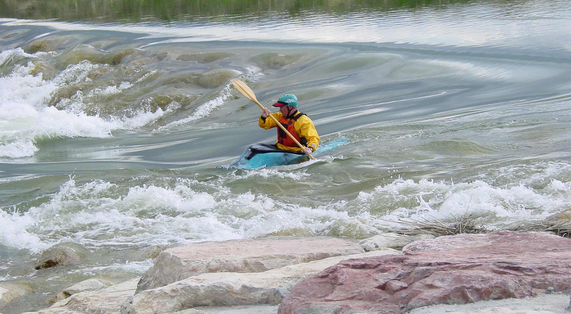 A person kayaking through whitewater in Casper, Wyoming