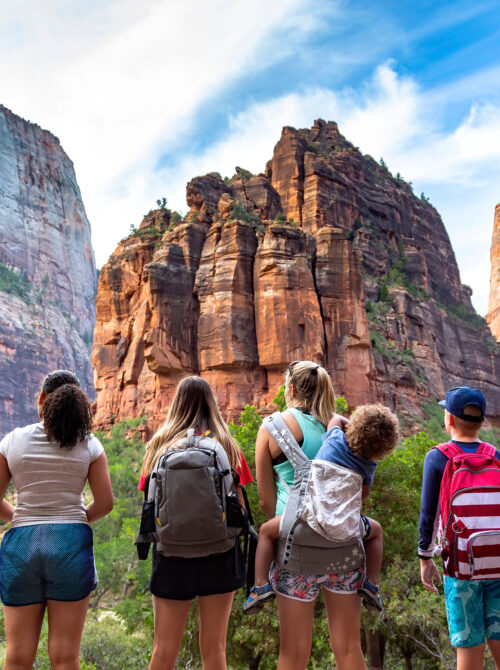 family looking up at zion national park