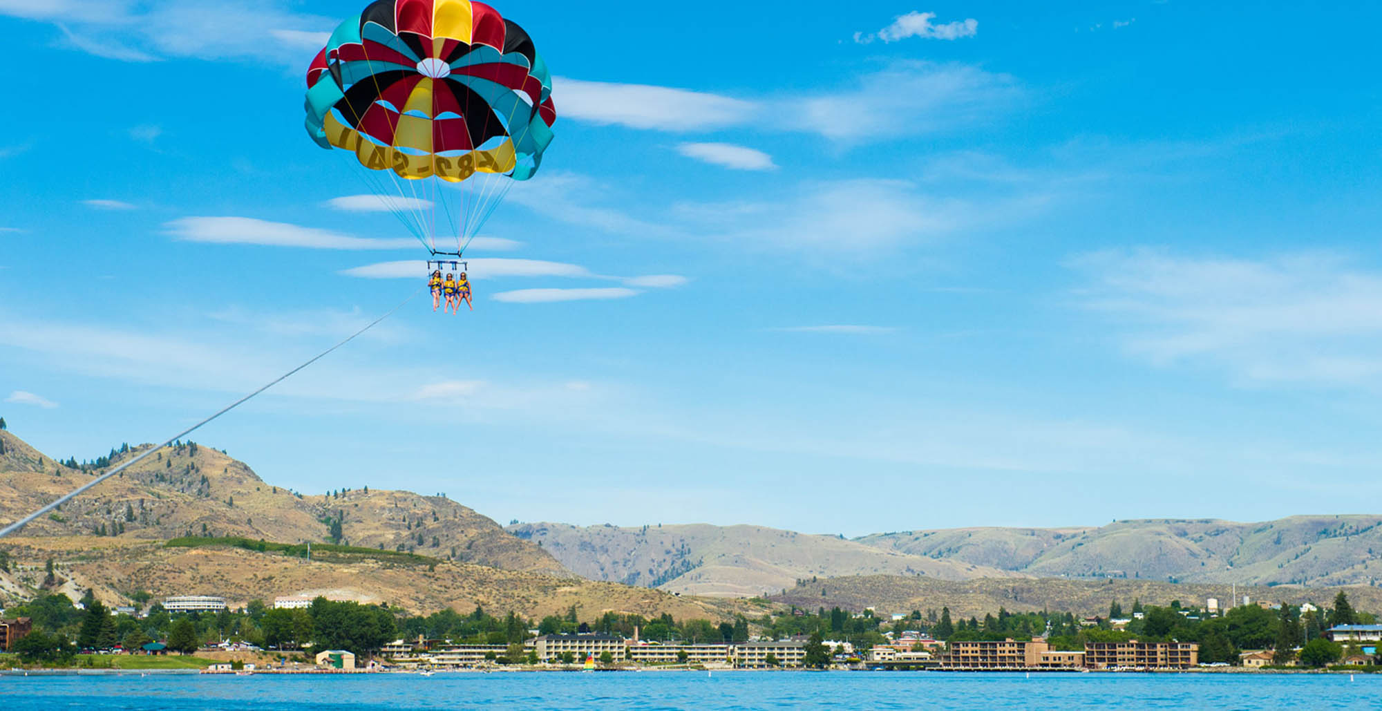 Parasailing over Lake Chelan in Chelan, Washington; Credit: Lake Chelan Chamber of Commerce

