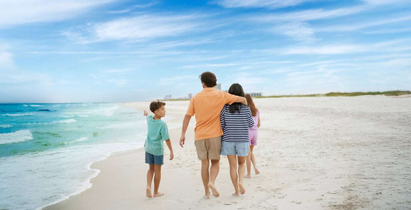 Family walking along Alabama's white-sand Gulf beaches