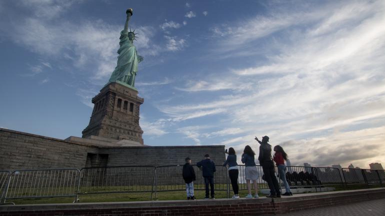 People Looking at Statue Liberty