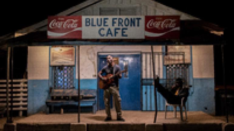 Man plays guitar at the Blue Front Cafe