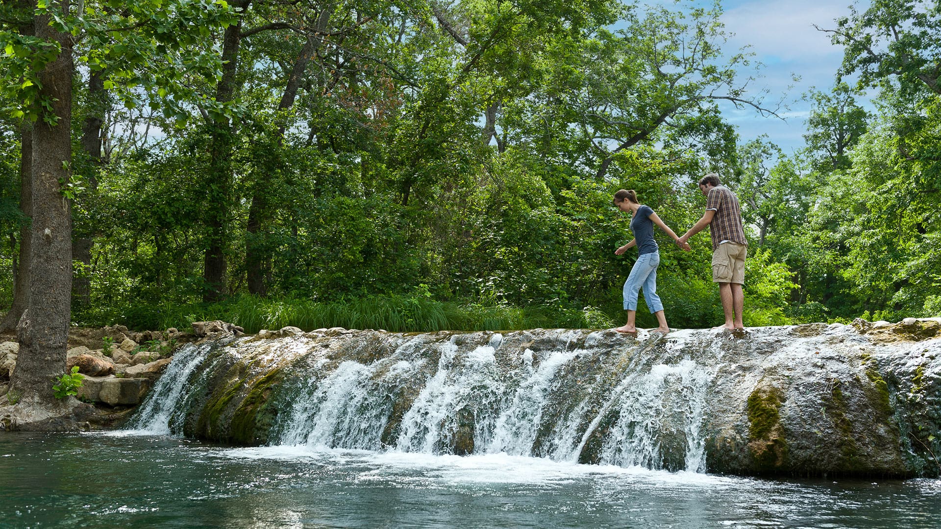 People relaxing at the Turner Falls in Davis, Oklahoma; Credit: Courtesy Chickasaw Country
