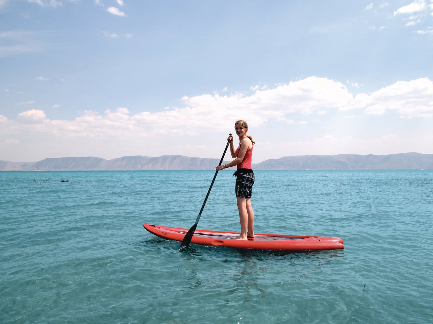 Woman on a paddleboard on Bear Lake near Pocatello, Idaho